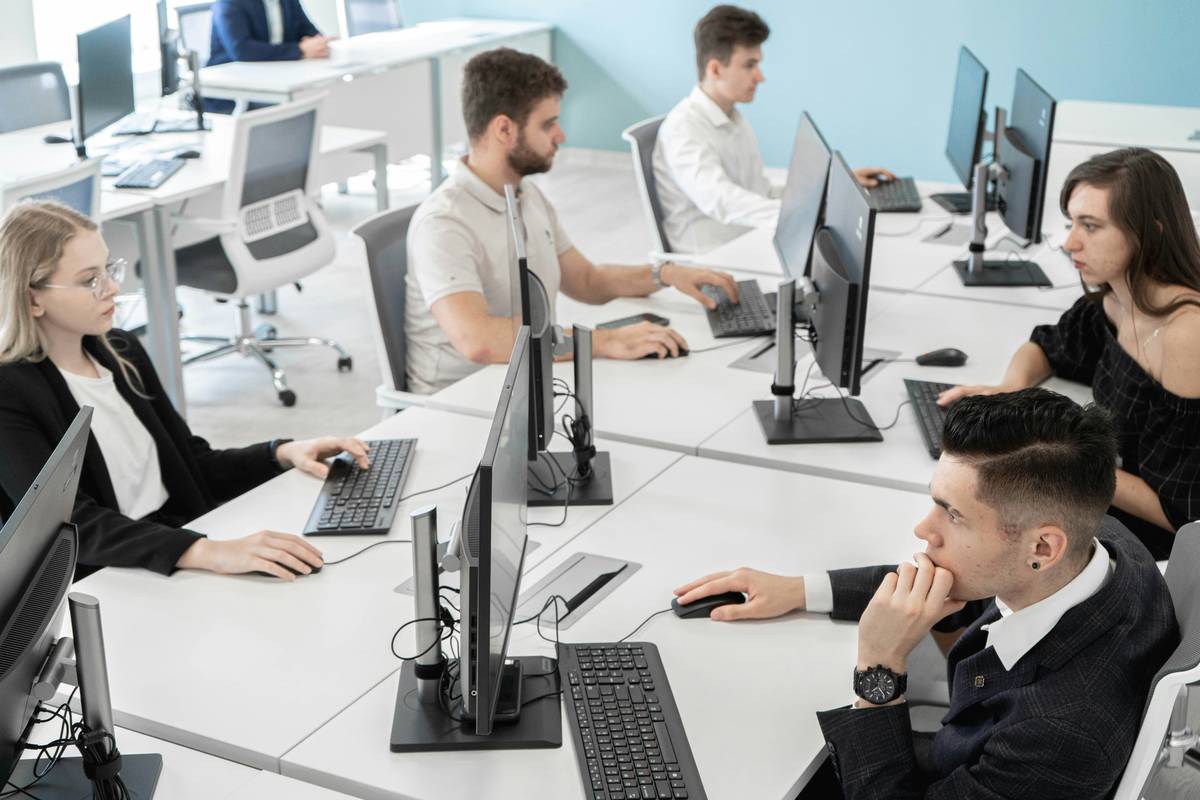 Employees participating in interactive Employee Training Programs on cybersecurity threats