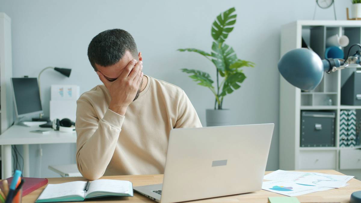 Ransom Negotiation FAQs: A person reviewing a cyber extortion insurance policy while communicating with a professional negotiator